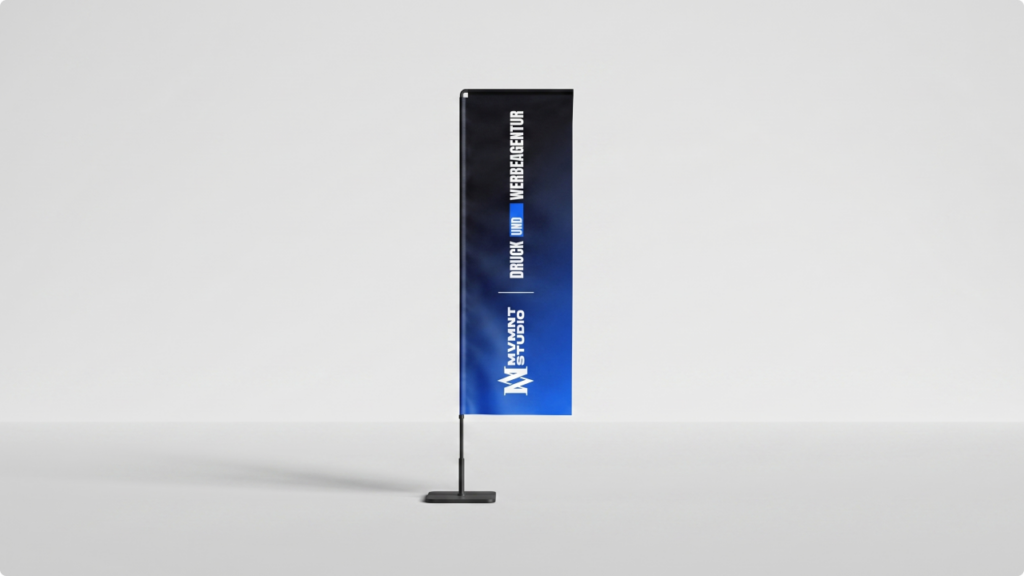 Freestanding vertical banner on a slim black pole with a square base, gradient black-to-blue, displaying a design/branding for a studio in bold white text (empty studio background).