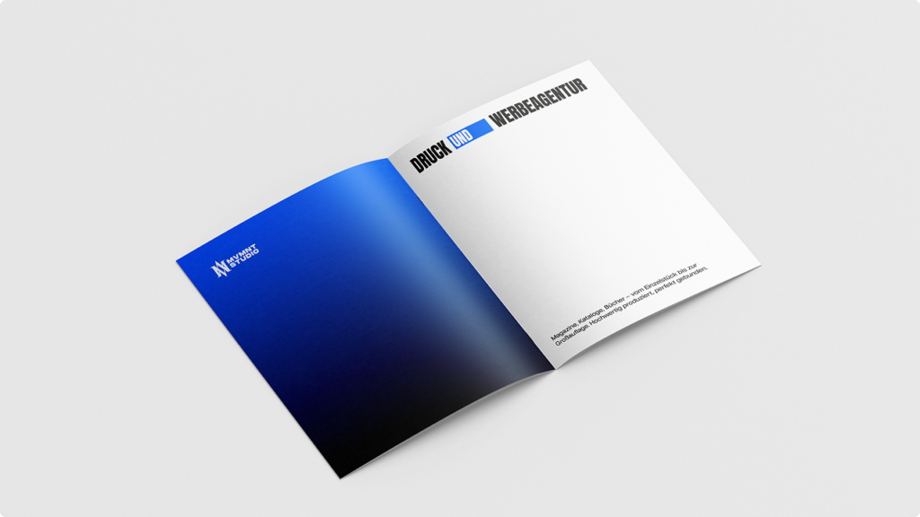 Open brochure on a light surface: left page features a dark blue gradient, right page is white with black German text (branding layout).