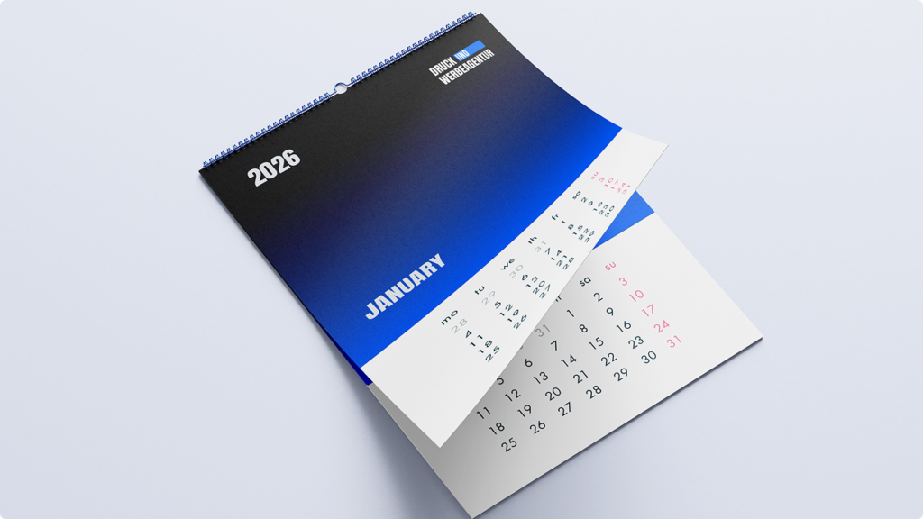 Spiral-bound 2026 calendar open to January with a blue-to-black gradient cover.
