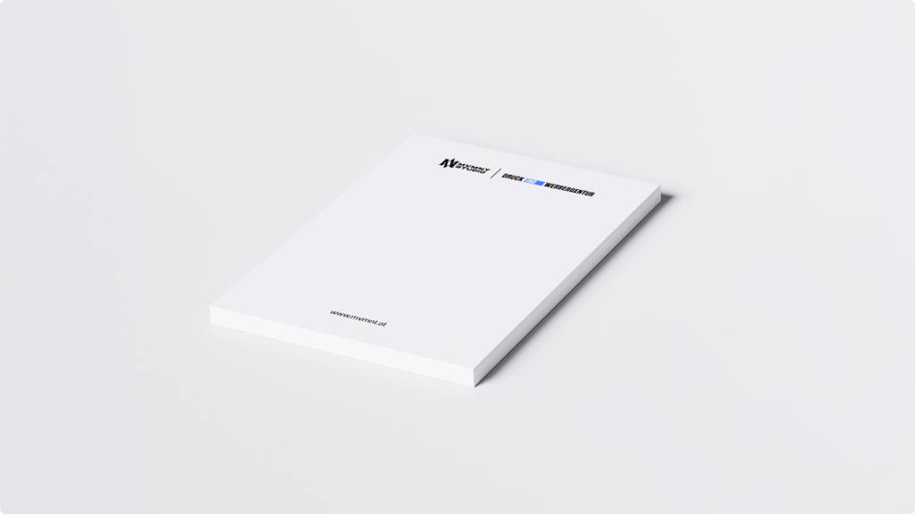 Minimal white booklet on a white surface, with small logos near the top edge and a small URL along the bottom edge.