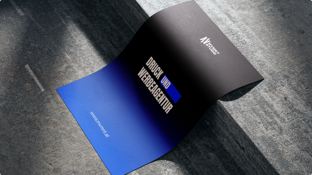 Curved promotional flyer with a black-to-blue gradient, bold white typography and a blue accent bar, placed on a concrete surface. URL text appears on the blue area in the corner.