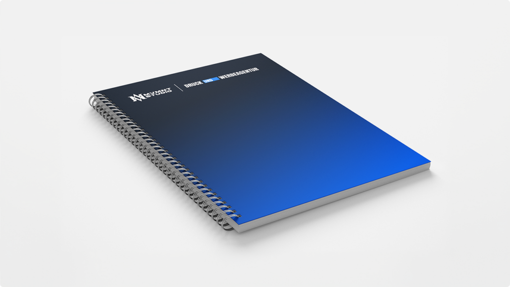 Spiral-bound notebook with a dark-to-blue gradient cover on a white surface.